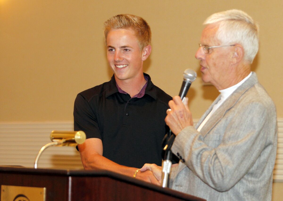Estancia's Jake Knapp, left, is congratulated by his grandfather Gordon Bowley during a 2012 scholarship  awards breakfast.