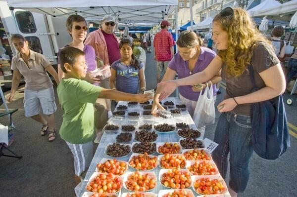 Shaheen Zekavat (far left) of Circle C Ranch in Lake Hughes, sells her family's cherries (Rainier and Jubilee varieties depicted here) and famous Persian mulberries at the Hollywood farmers market,