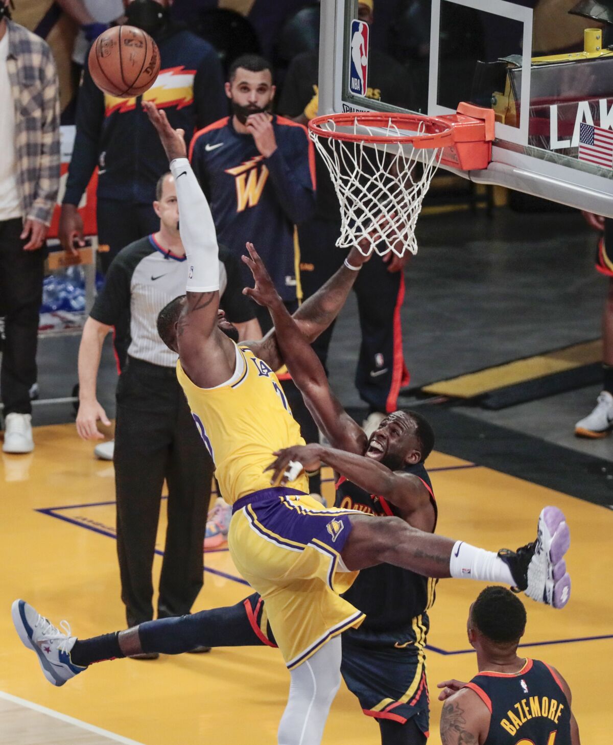 Basketball players collide at the net