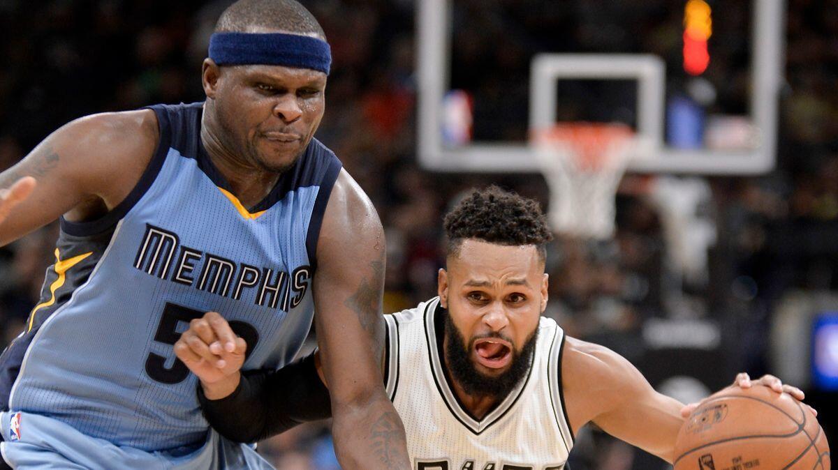 San Antonio Spurs guard Patty Mills, right, drives against Memphis Grizzlies forward Zach Randolph during the second half on April 4.