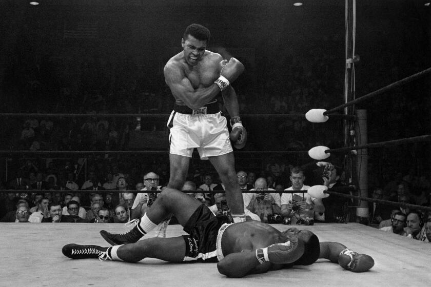 Heavyweight champion Muhammad Ali stands over fallen challenger Sonny Liston