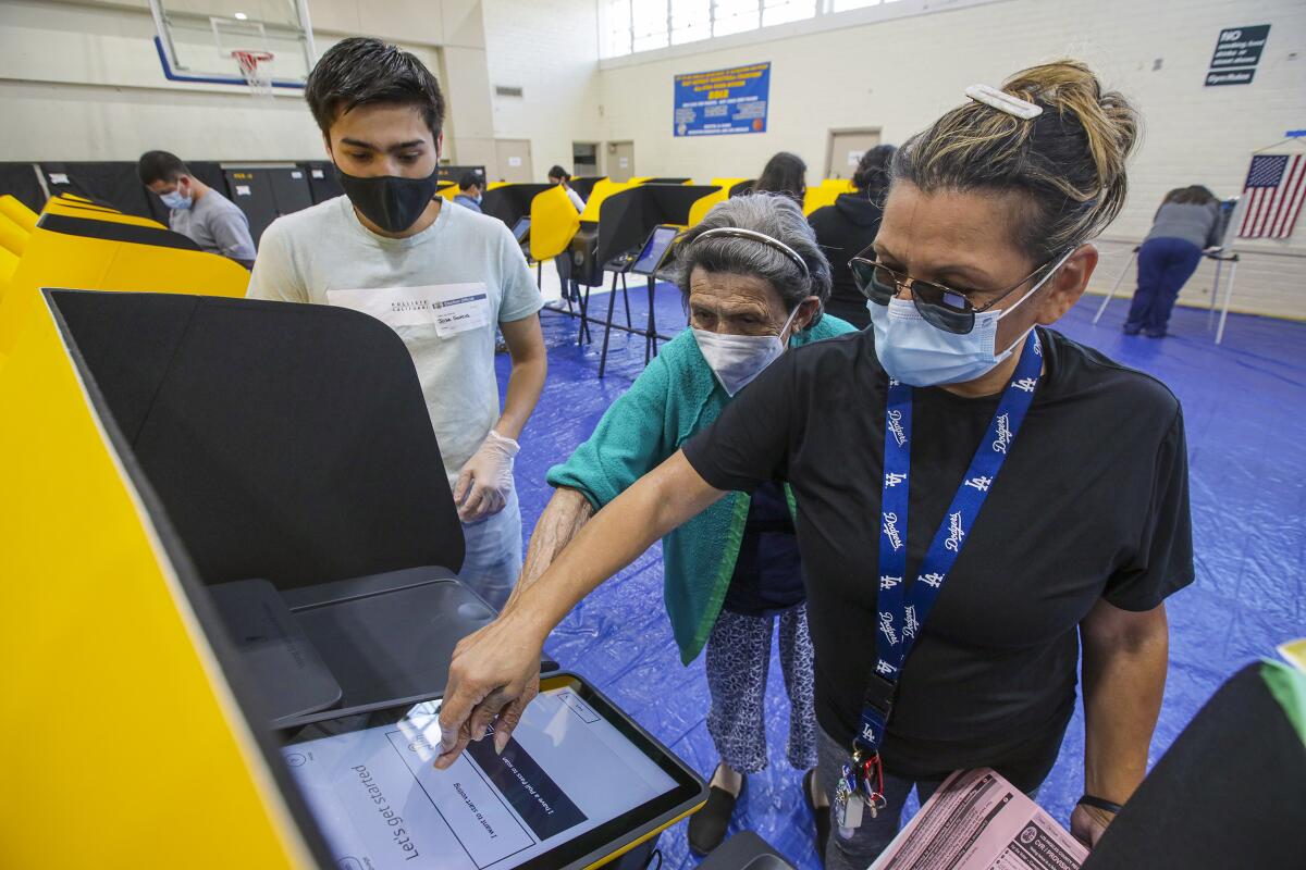 Sonia Murillo, 53, right, helps her 86-year-old mother Graciela Murillo in navigating Ballot Marking Device.