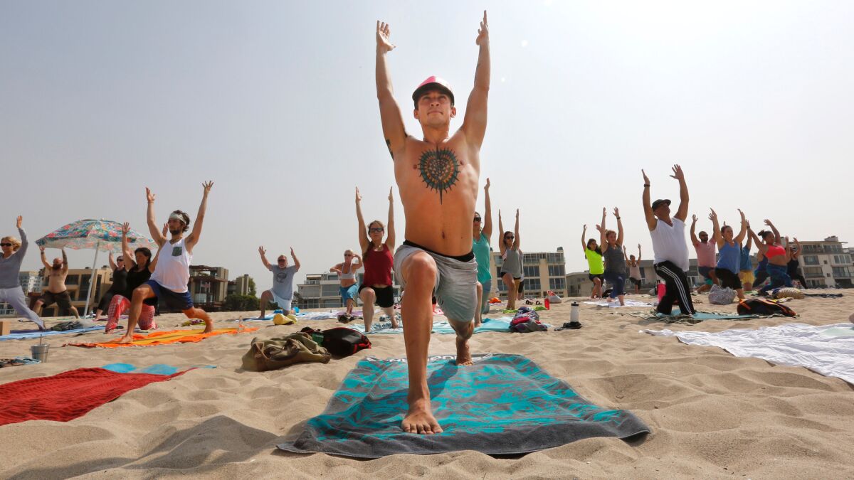 Bogdan Bikish practices yoga on the beach. On any given Saturday morning, a diverse group of people gather on the beach off Hurricane Street in Marina del Rey to practice the ancient discipline of yoga.