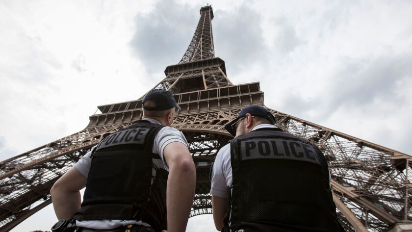 French police officers patrol near the Eiffel Tower last year.