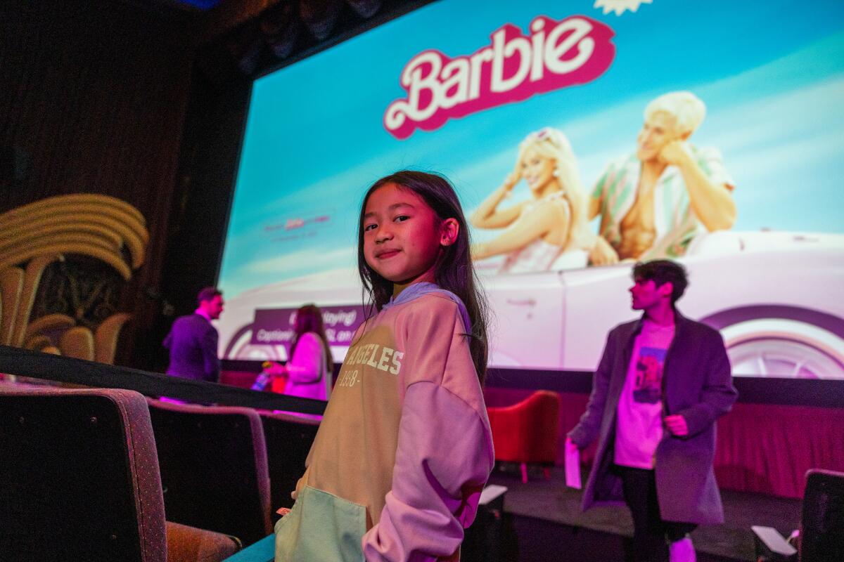Oceana Matsumoto poses in front of the screen at the premier of "Barbie" with ASL.