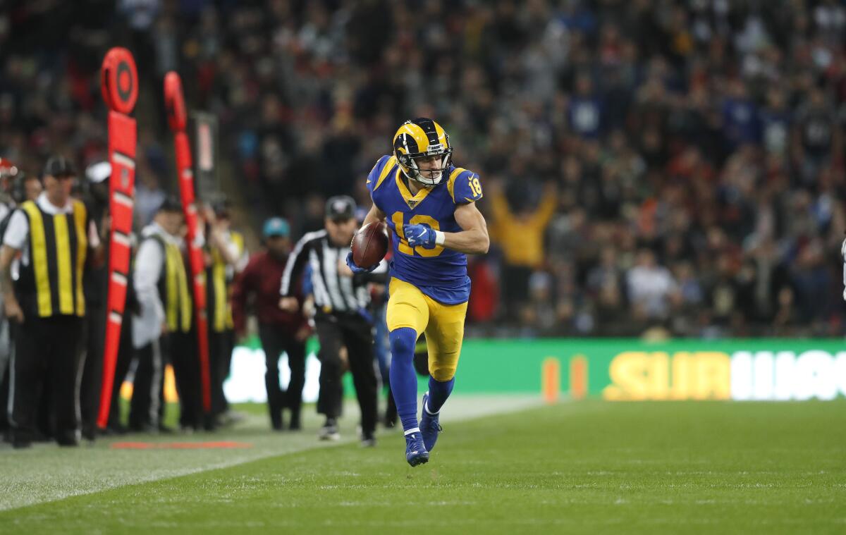Rams wide receiver Cooper Kupp runs down the sideline after making a reception on a double-reverse pass.