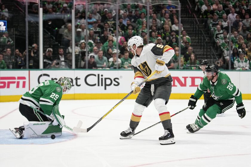 Dallas Stars goaltender Jake Oettinger (29) deflects a shot from Vegas Golden Knights center Jack Eichel (9), while Stars defenseman Ryan Suter (20) watches during the second period of Game 4 of the NHL hockey Stanley Cup Western Conference finals Thursday, May 25, 2023, in Dallas. (AP Photo/Tony Gutierrez)