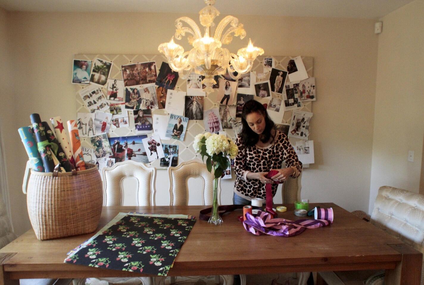 Aya Sumika at the Crate & Barrel dining table, also used for work. An inspiration board may seem like an unlikely choice for a dining area, but if you're spending much time there, it makes sense.