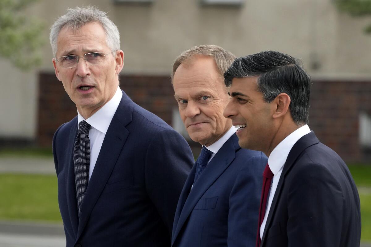 The prime ministers of Poland and Britain and NATO secretary general in Warsaw