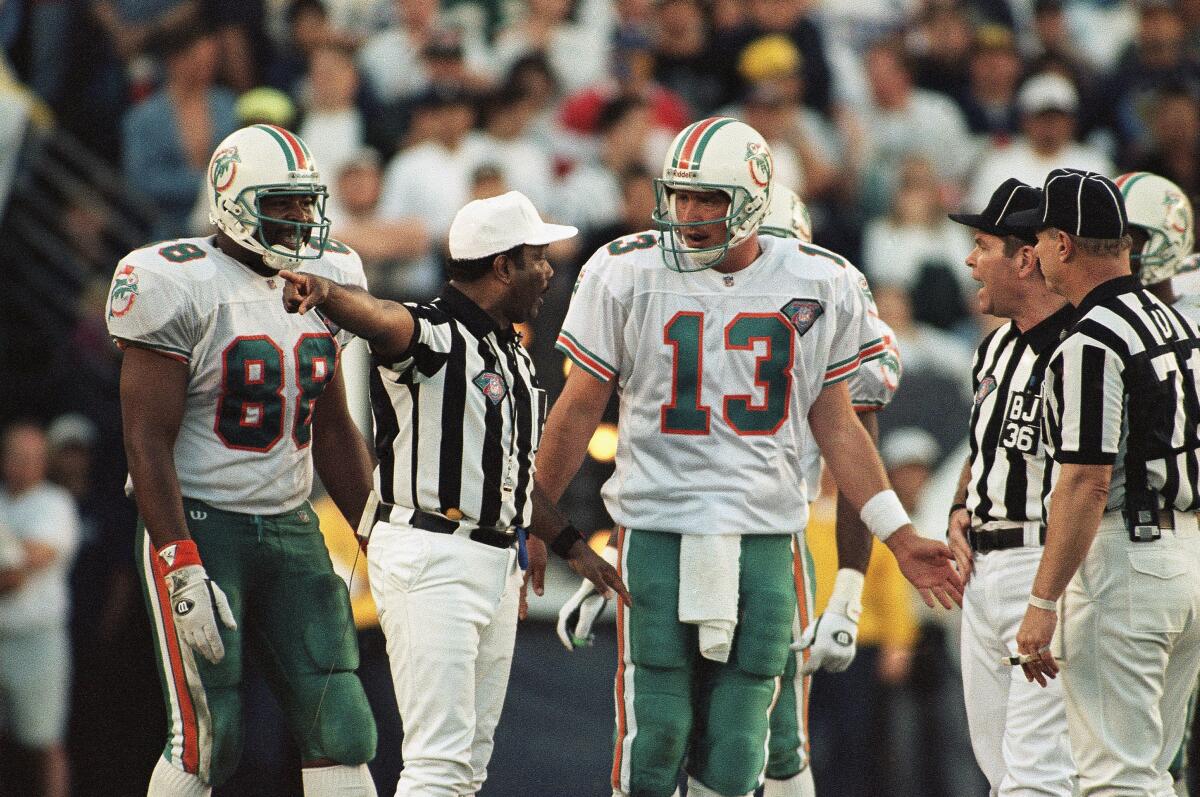 Miami Dolphins' quarterback Dan Marino (13) argues with referee Johnny Grier