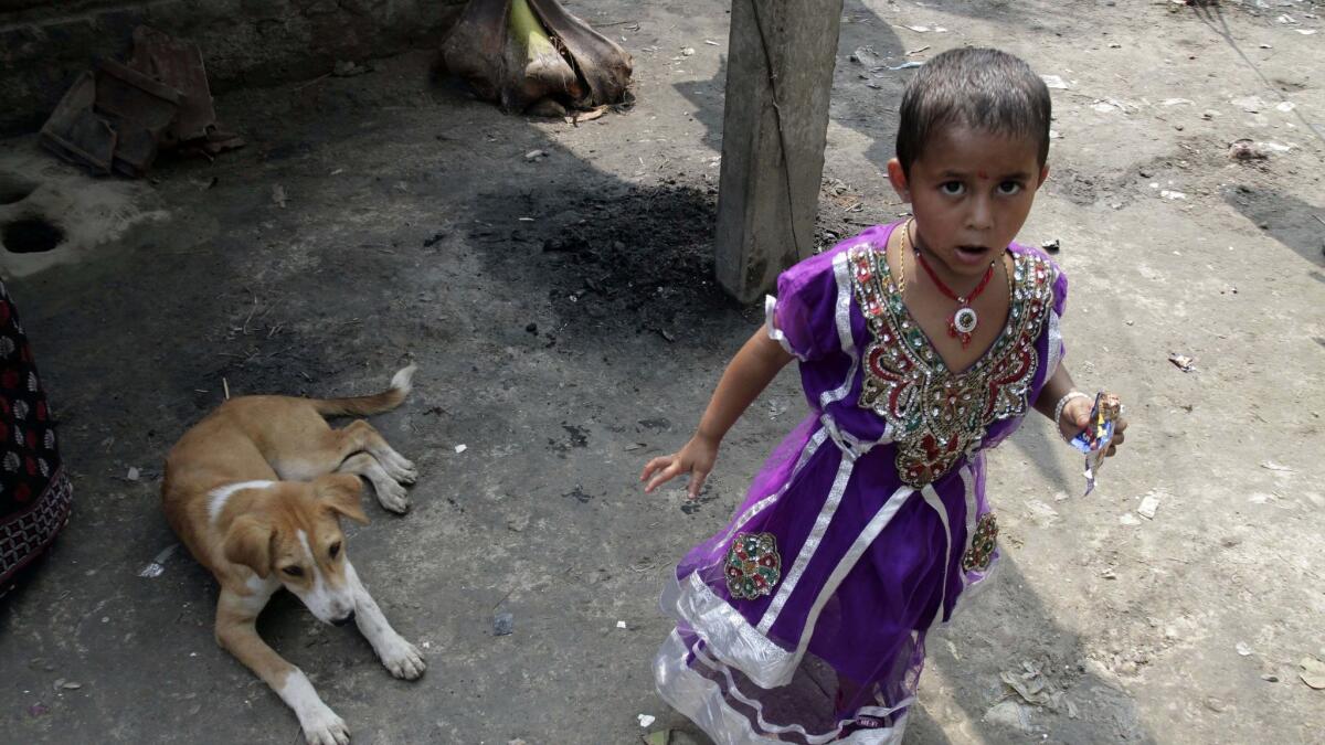 In this 2014 file photo, Rukhsar Khatoon, the last person in India to contract polio, stands in the courtyard of her home in Shahpara Village, 40 miles west of Kolkata, India.