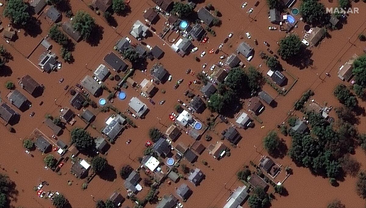 In a satellite image provided by Maxar Technologies, homes along Boessel Ave., in Manville, N.J. are surrounded by floodwaters Thursday, Sept. 2, 2021, after remnants of Hurricane Ida swept through the area (Satellite image ©2021 Maxar Technologies via AP)