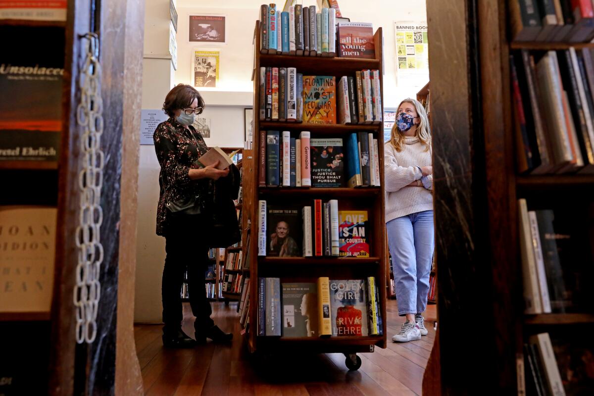 People browse the shelves of the City Lights bookstore.