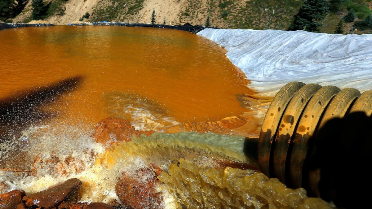 Orange-colored water in a retention pools built to contain the contaminated water that exploded from the Gold King Mine in 2015.