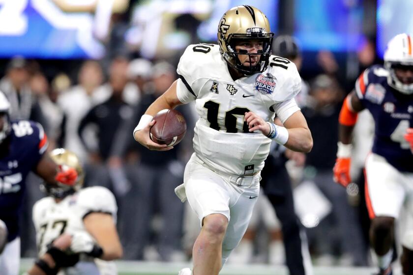 ATLANTA, GA - JANUARY 01: McKenzie Milton #10 of the UCF Knights runs on his way to scoring a touchdown in the second quarter against the Auburn Tigers during the Chick-fil-A Peach Bowl at Mercedes-Benz Stadium on January 1, 2018 in Atlanta, Georgia. (Photo by Streeter Lecka/Getty Images) ** OUTS - ELSENT, FPG, CM - OUTS * NM, PH, VA if sourced by CT, LA or MoD **