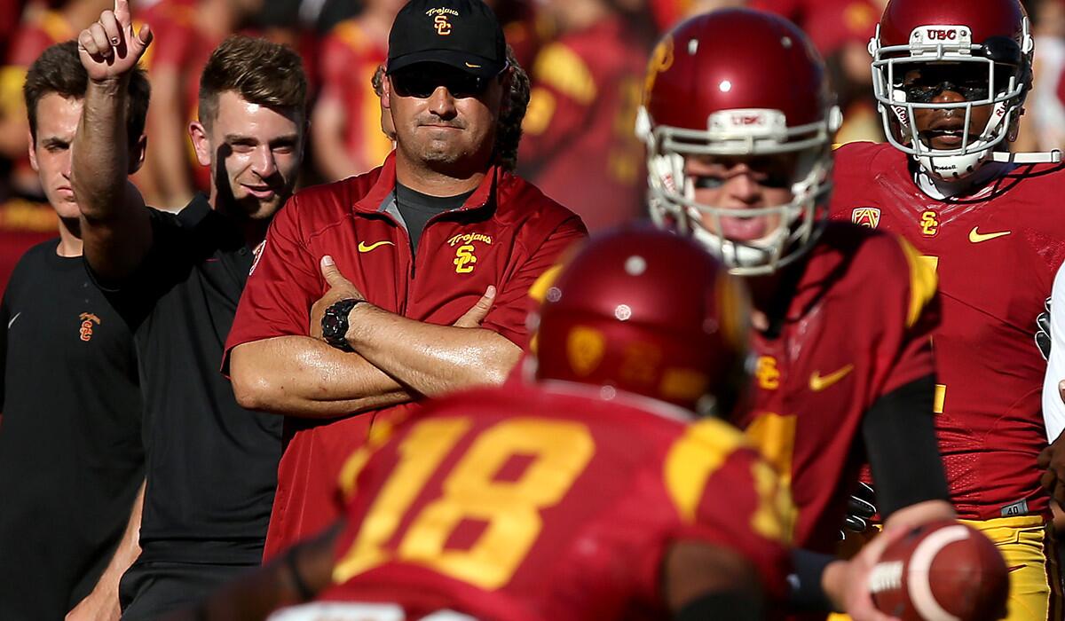 USC Coach Steve Sarkisian watches the Trojans warm up before their game against Arizona State on Saturday at the Coliseum.