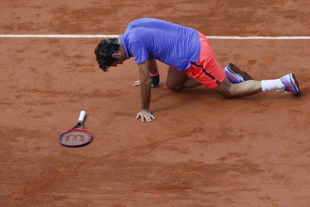 Switzerland's Roger Federer falls down during his men's quarterfinal match against Switzerland's Stanislas Wawrinka at the Roland Garros on Tuesday.