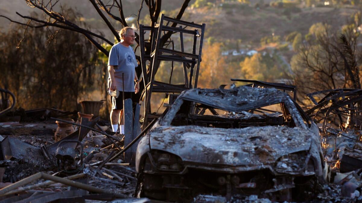 Dick Barton looks over his burned-out home at the Rancho Monserate Country Club on Monday, Dec. 11, 2017. The home, where he and his wife, Paula, had lived for 12 years, was destroyed in the Lilac fire.