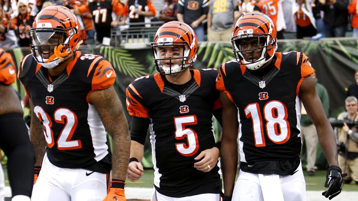 A.J. McCarron (5) will join running back Jeremy Hill (32) and wide receiver A.J. Green (18) in the starting lineup Sunday.