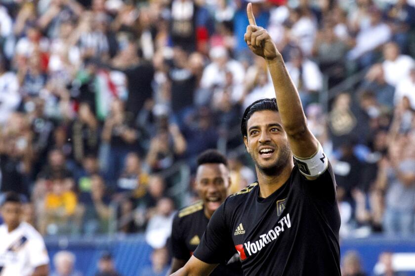 LAFC forward Carlos Vela (10) celebrates after scoring a goal during the first half of the game against the Galaxy on Friday night.