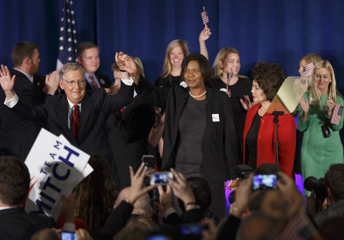Senate Minority Leader Mitch McConnell celebrates with Noelle Hunter, center, at an election night party in Louisville, Ky.