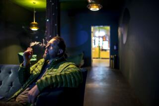 PALM SPRINGS, CA - JANUARY 31, 2023: Shannon Graham smokes marijuana inside the lounge at Reefer Madness on January 31, 2023 in Palm Springs, California. (Gina Ferazzi / Los Angeles Times)