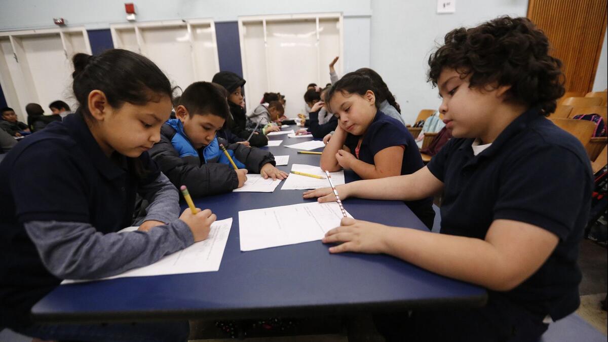 First grade students work together in the auditorium at 99th Street Elementary School in South Los Angeles on the 4th day of the LA teachers' strike on Jan. 17.