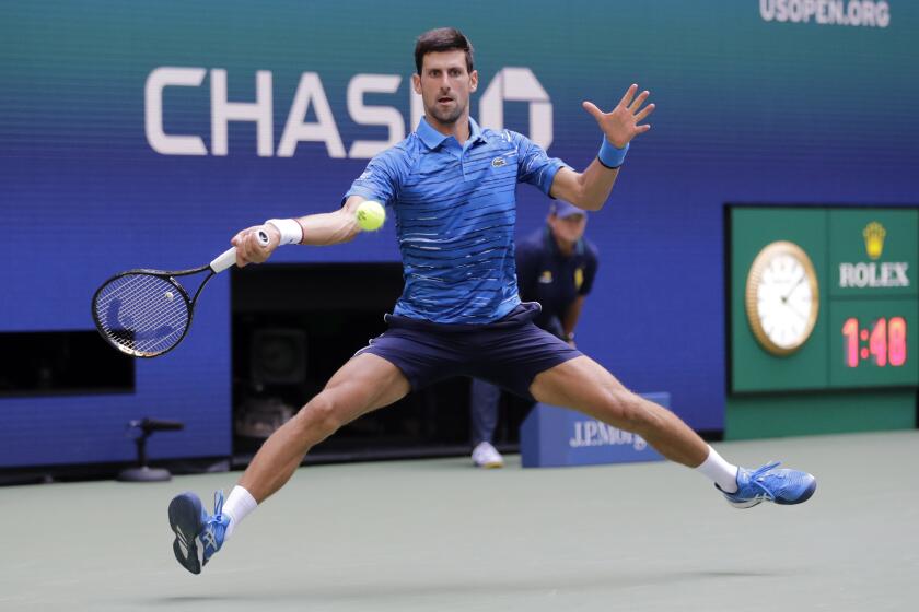 Novak Djokovic, of Serbia, returns a shot to Roberto Carballes Baena, of Spain, during the first round of the US Open tennis tournament Monday, Aug. 26, 2019, in New York. (AP Photo/Frank Franklin II)