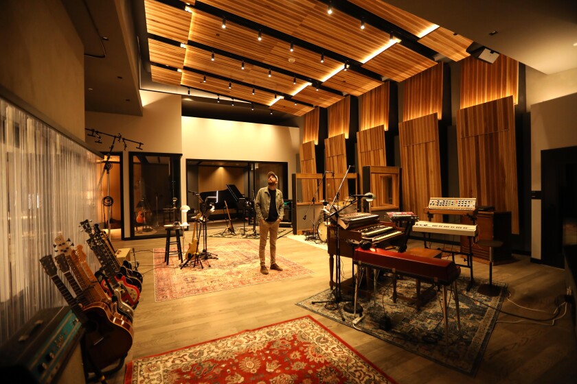 Inside a studio with glowing wood walls.