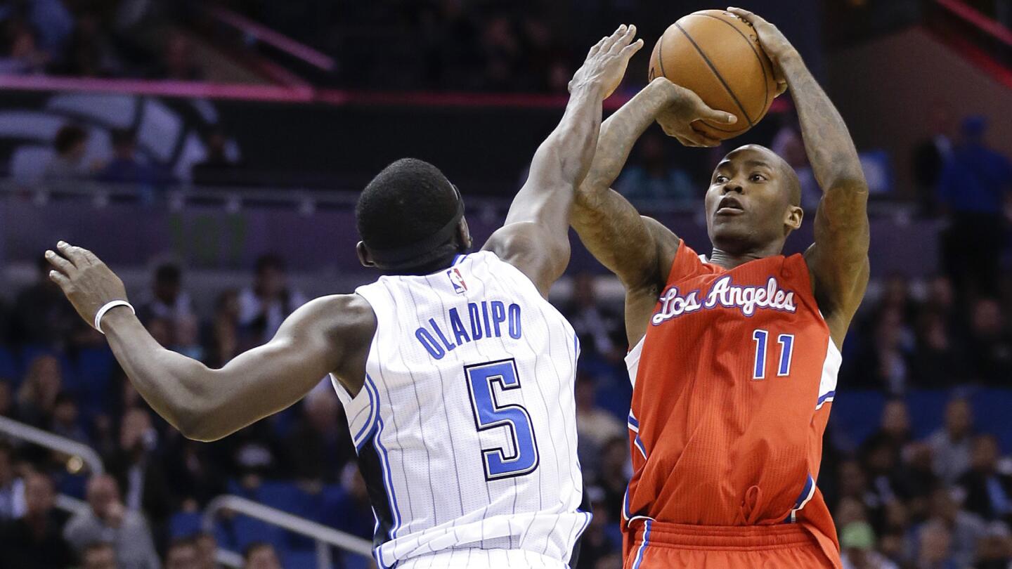 Clippers guard Jamal Crawford, right, shoots over Orlando Magic guard Victor Oladipo during the first half of Wednesday's game.