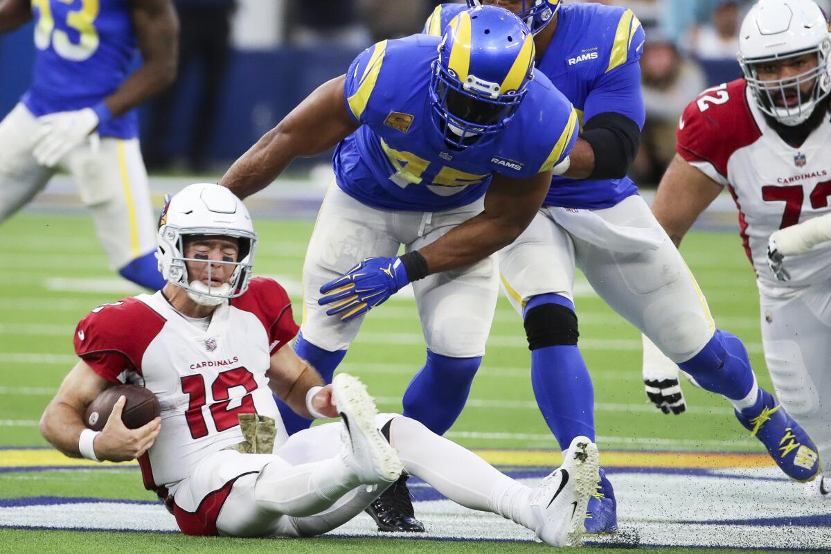 Cardinals quarterback Colt McCoy falls to the ground after being sacked in front of Rams linebacker Bobby Wagner.
