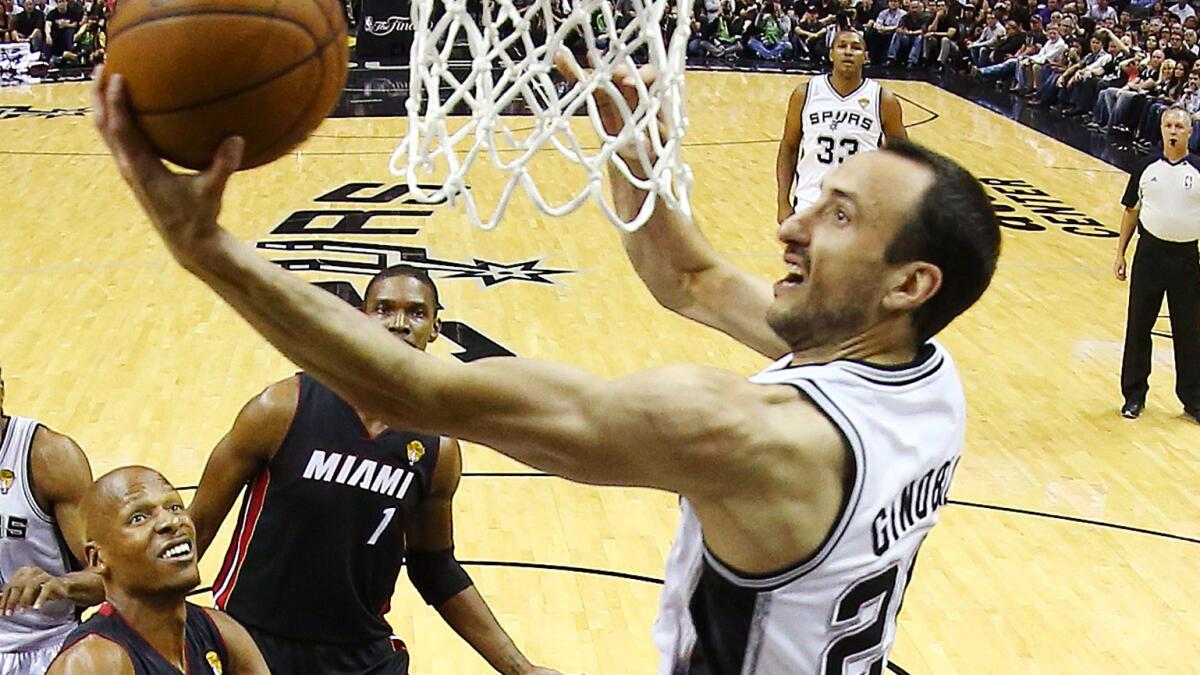 San Antonio Spurs guard Manu Ginobili puts up a shot during the team's 98-96 loss to the Miami Heat in Game 2 of the NBA Finals on Sunday night.