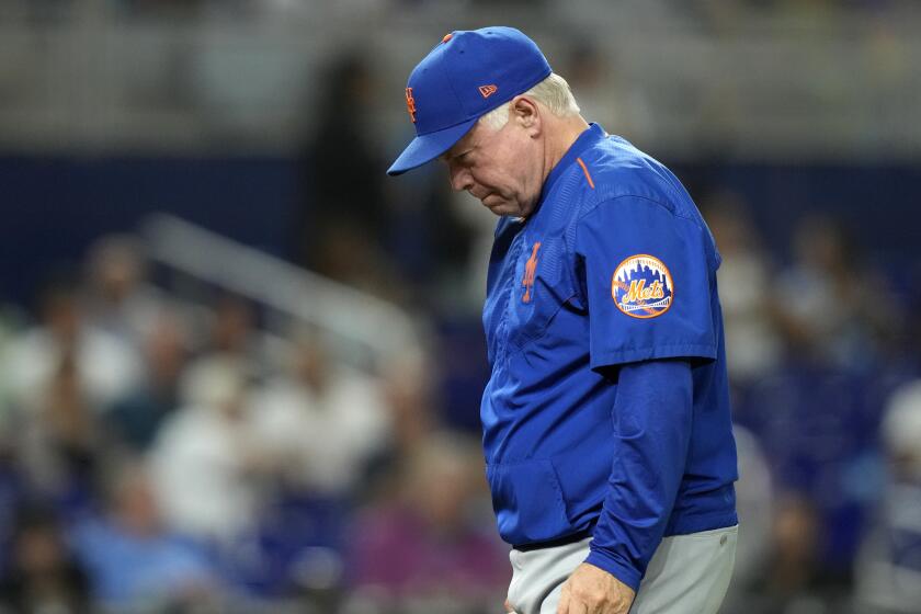 New York Mets manager Buck Showalter walks from the mound after a pitching change during the eighth inning of a baseball game against the Miami Marlins, Wednesday, Sept. 20, 2023, in Miami. (AP Photo/Lynne Sladky)