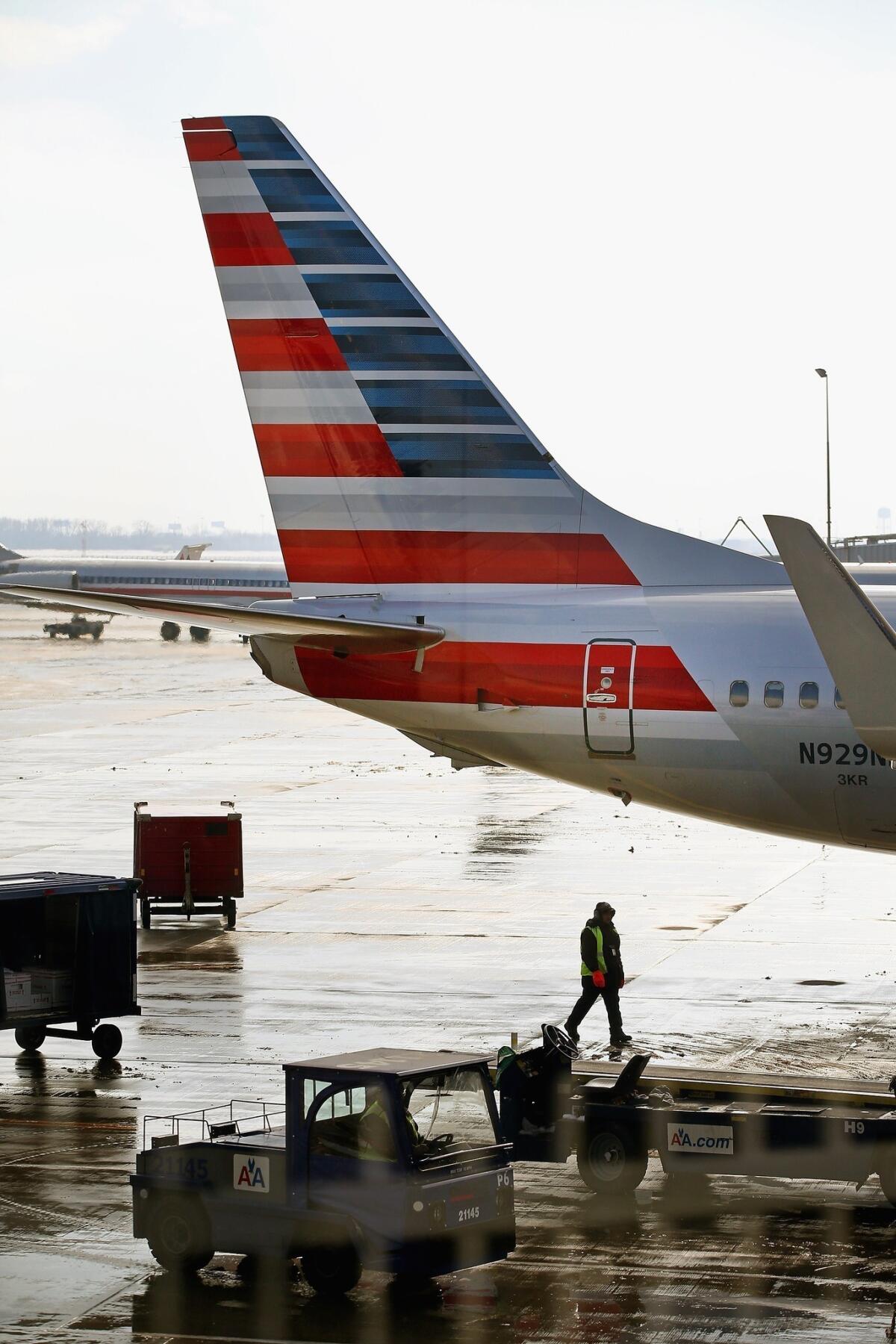 An American Airlines jet with a striped tail sits at Chicago O'Hare International Airport.