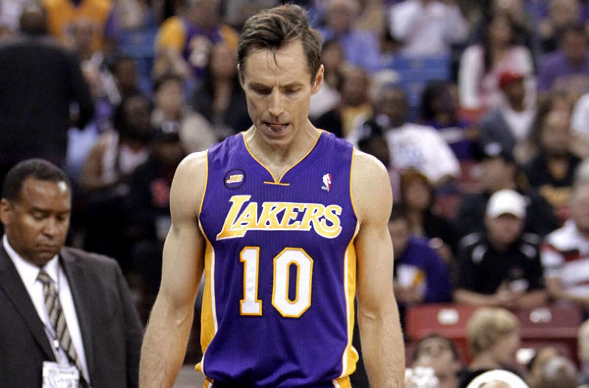 Lakers guard Steve Nash walks to the locker room after injuring his hamstring during the first quarter of a game against the Sacramento Kings.