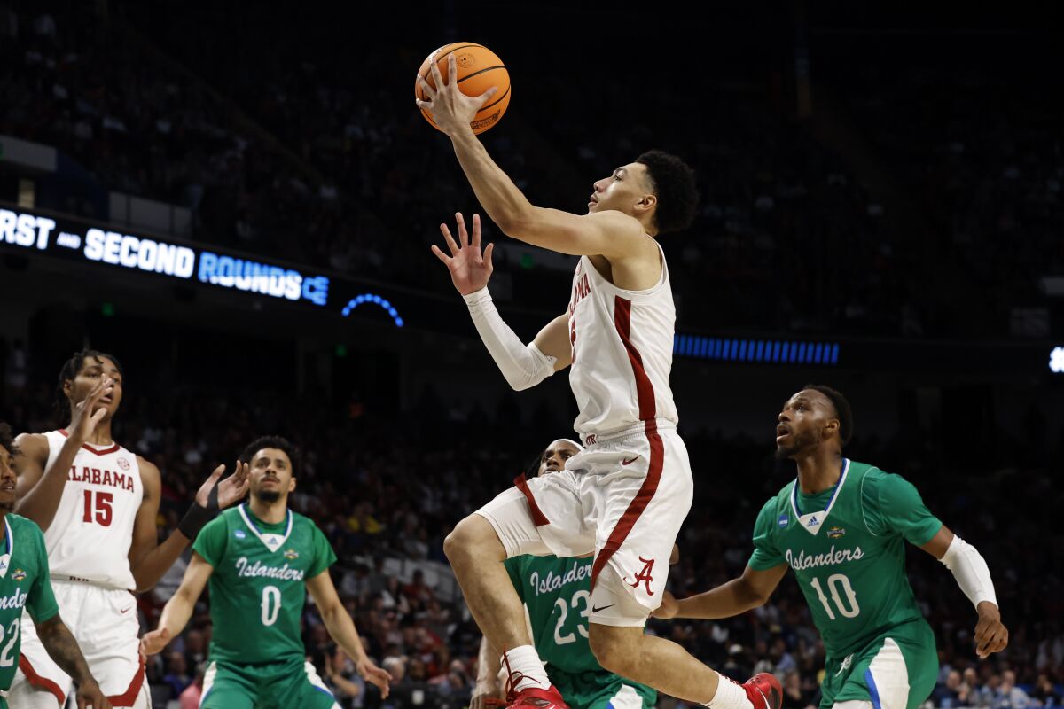 Alabama guard Jahvon Quinerly (5) last in a basket against Texas A&M Corpus Christi in the first half of a first-round college basketball game in the NCAA Tournament in Birmingham, Ala., Thursday, March 16, 2023. (AP Photo/Butch Dill)