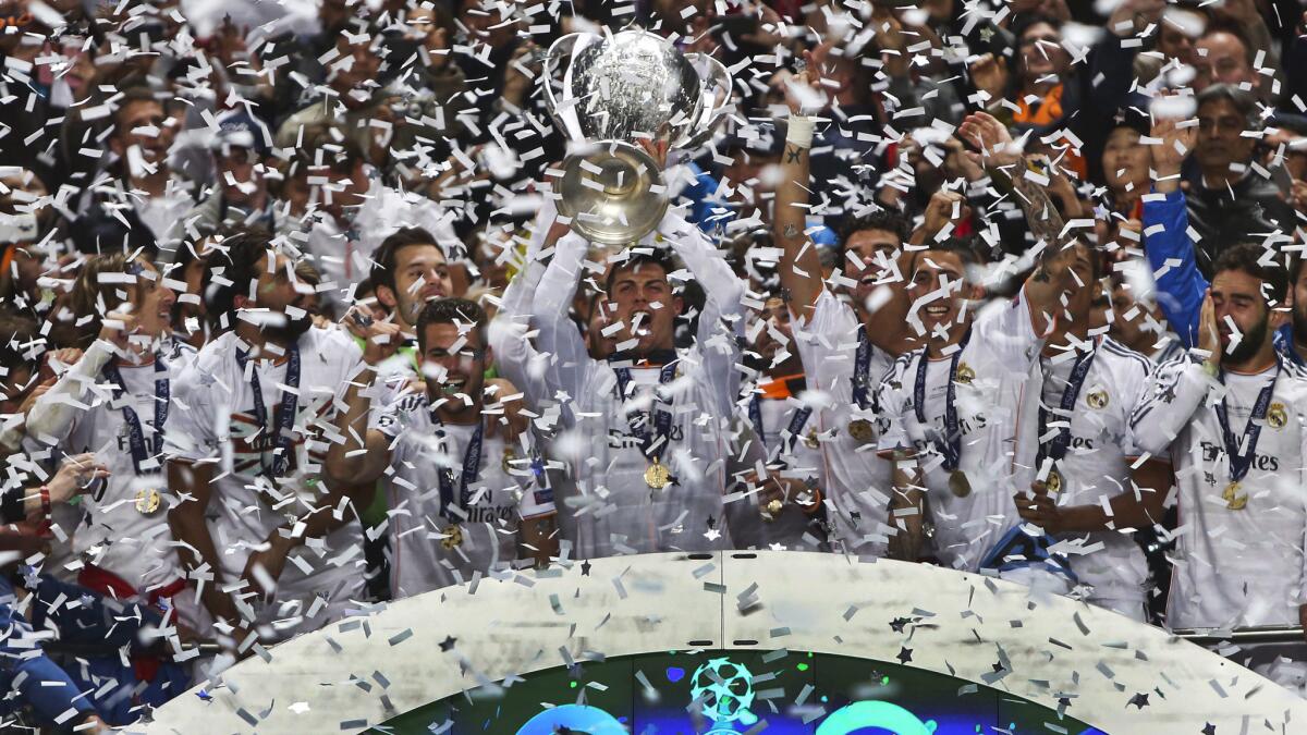 Cristiano Ronaldo, center, celebrates with his Real Madrid teammates following their victory over Atletico Madrid in the UEFA Champions League final Saturday.