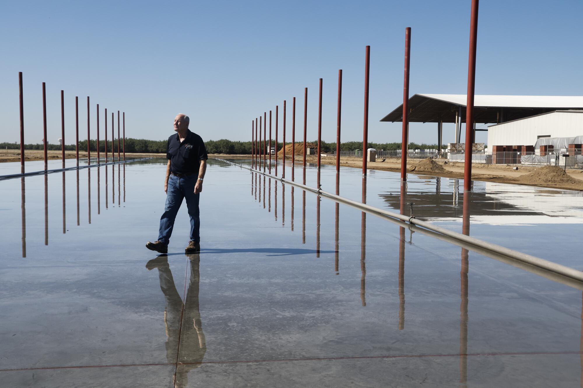 David Phippen walks on his new warehouse that is under construction in Manteca.