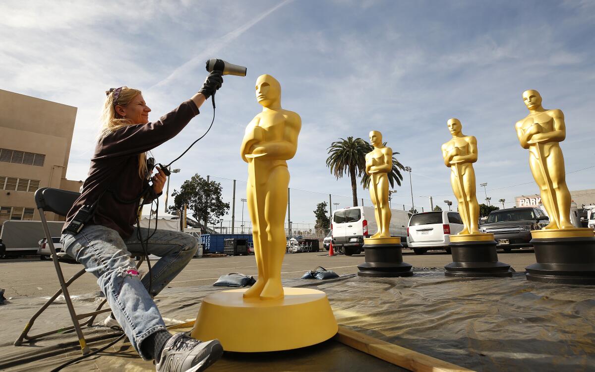 Lead scenic artist Dena D’Angelo dries freshly painted Oscar statues in preparation for Sunday's 92nd Academy Awards ceremony at the Dolby Theatre in Hollywood.