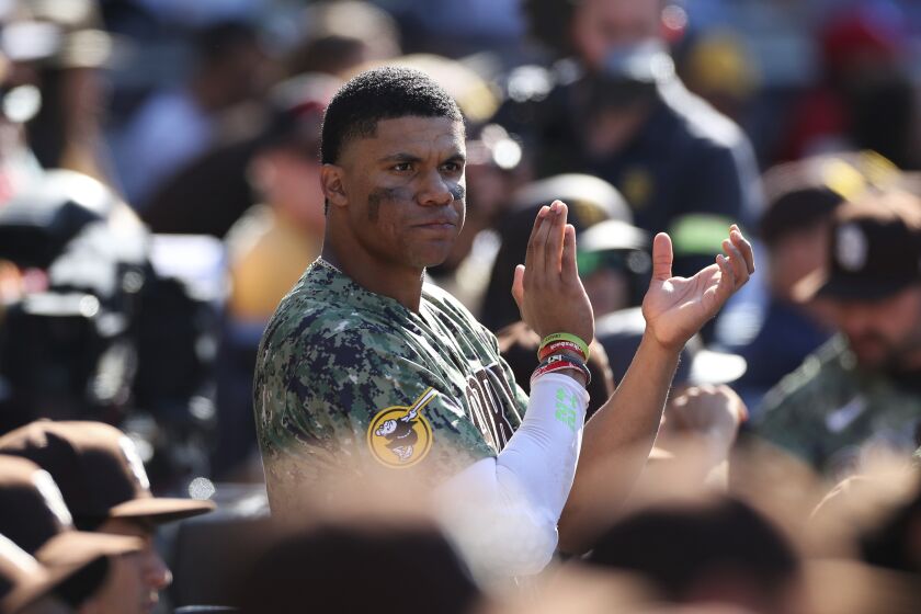 San Diego Padres' Juan Soto claps after the team clinched a playoff spot in the seventh inning of a baseball game against the Chicago White Sox, Sunday, Oct. 2, 2022, in San Diego. (AP Photo/Derrick Tuskan)