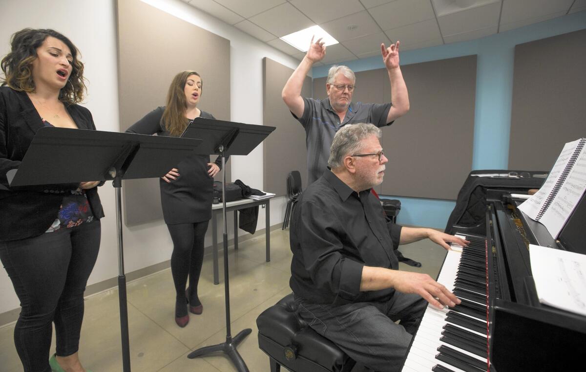 Neely Bruce, playing piano, and Don Brinegar rehearse with L.A. Opera sopranos Katherine Giaquinto, left, and Marina Harris.
