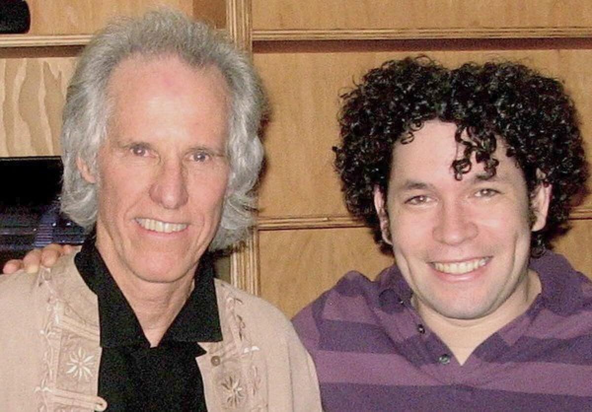 John Densmore, left, with Gustavo Dudamel. They have more than long hair and waving sticks in common.