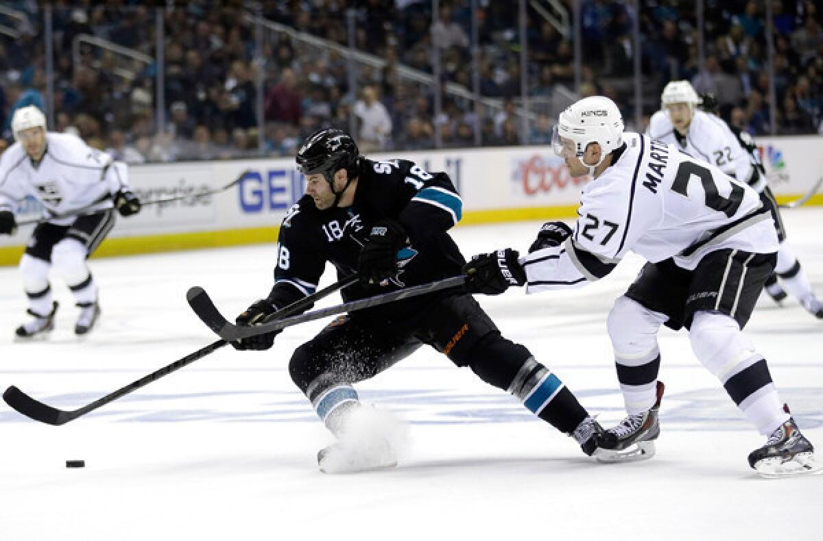 Kings defenseman Alec Martinez, battling Sharks winger Mike Brown for the puck Thursday night, says of the 6-3 loss in Game 1: "We'll learn from it, and that's why there's seven games."