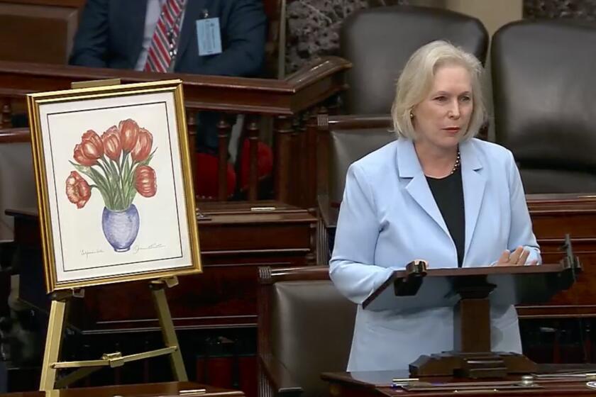 This image from U.S. Senate video, Sen. Kirsten Gillibrand, D-N.Y., speaks about the late Sen. Dianne Feinstein in the Senate chamber on Friday, Sept. 29, 2023, in Washington. Gillibrand brought a drawing Feinstein had given her and wore red lipstick in her honor. (Senate Television via AP)