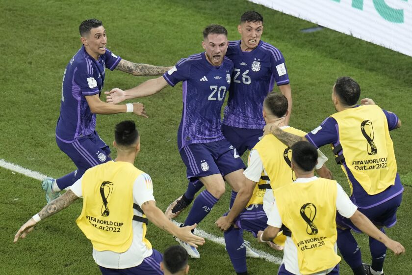 Argentina's Alexis Mac Allister, center, celebrates with this teammates after scoring his side's opening goal during the World Cup group C soccer match between Poland and Argentina at the Stadium 974 in Doha, Qatar, Wednesday, Nov. 30, 2022. (AP Photo/)