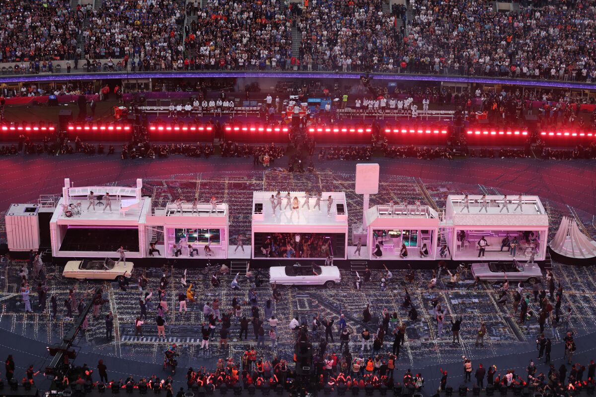 Performers, dancers and lowrider cars on the field for the halftime show at SoFi Stadium.