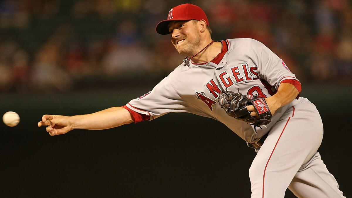 Angels closer Joe Smith delivers a pitch during the ninth inning of the team's 5-2 road win over the Texas Rangers on Saturday.
