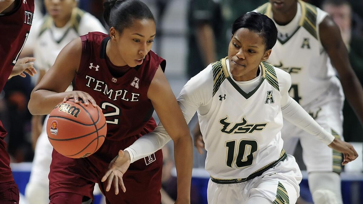 South Florida’s Courtney Williams (10) goes for a steal against Temple’s Feyonda Fitzgerald during an AAC tournament game March 6.