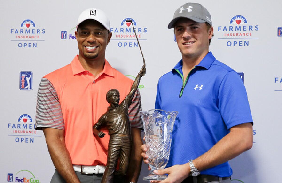 Tiger Woods, left, 2013 PGA Tour Player of the Year and Jordan Spieth, PGA Tour Rookie of the Year, pose with their trophies during a news conference at Torrey Pines Golf Course on Wednesday.