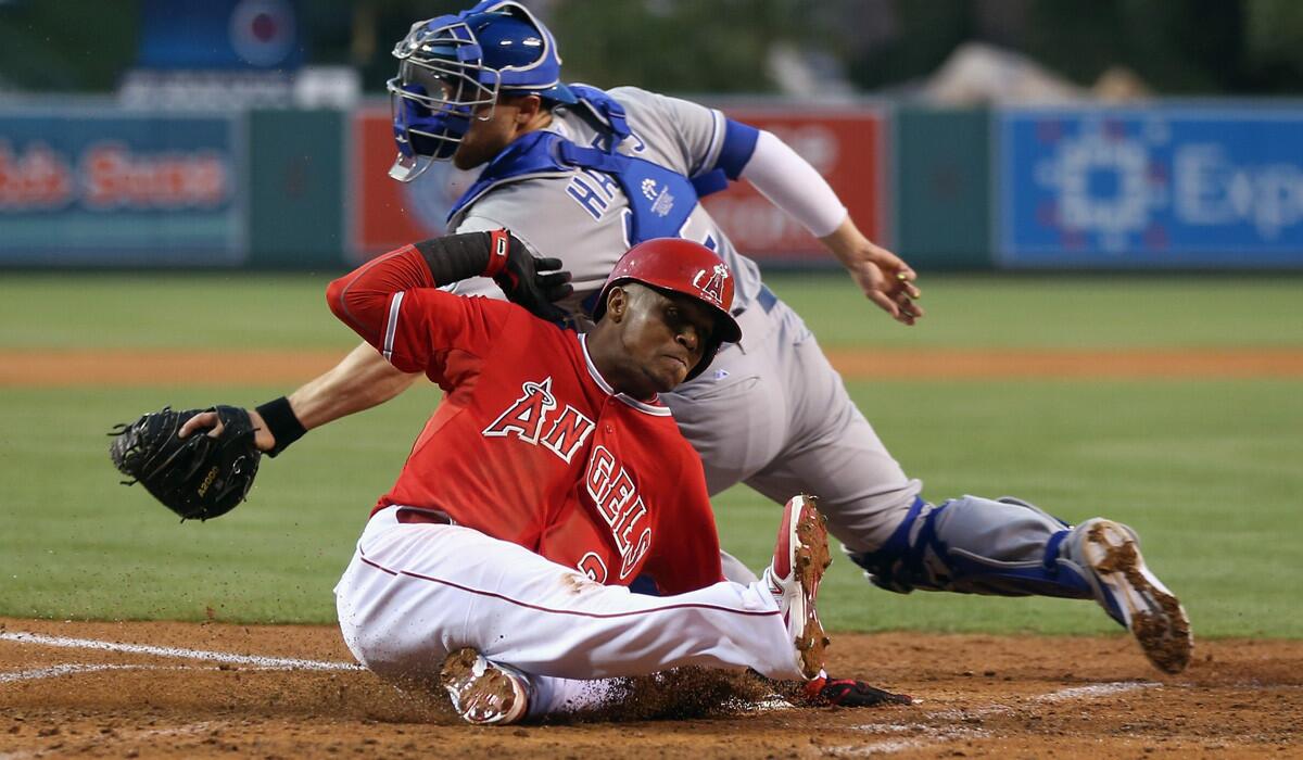 Angels shortstop Erick Aybar slides home safely before Royals catcher Brett Hayes can make the tag following a hit by Collin Cowgill in the second inning Friday night in Anaheim.